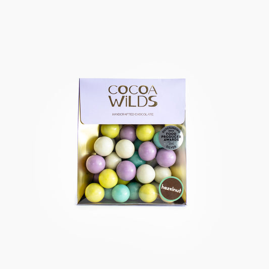 Award winning Caramelised Milk Chocolate Hazelnuts with visible white, blue, pink, and yellow chocolate covered hazelnuts