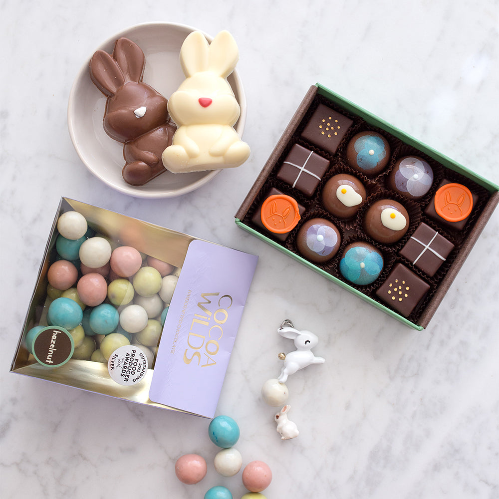 Chocolate marshmallow bunnies, colorful, pastel coloured chocolate hazelnuts and a hand decorated, Easter themed chocolate box in a 12 piece assortment.
